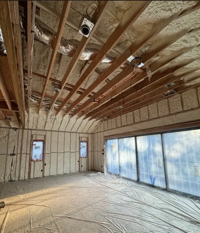 Interior walls and ceiling insulated with spray foam during new construction in Whitefish Bay